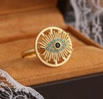 Gold Plated Ring with Eye Design and Sunburst Pattern in Blue and Black Stones for Women