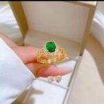 Gold Plated Ring with Green Stone Centerpiece and White Stones for Formal Events and Gifting