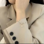 Elegant Pearl Bow Charm Bracelet - Image 3