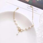 Elegant Pearl Bow Charm Bracelet