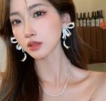 Elegant Silver Bow Crystal Drop Earrings for Women Sparkling Rhinestone Statement Jewellery for Party, Wedding, Festive and Stylish Special Occasion Wear - Image 4