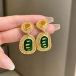 Elegant Green and Golden Drop Earrings for Women, Premium Geometric Design with Green Enamel Detailing, Amber Center Stones and Sparkling Crystal Border, Trendy Statement Fashion Jewellery for Party, Wedding and Festive Wear