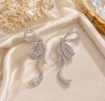 Elegant Silver Bow Crystal Drop Earrings for Women Sparkling Rhinestone Statement Jewellery for Party, Wedding, Festive and Stylish Special Occasion Wear